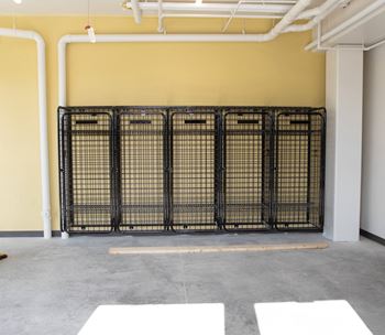 an empty room with a cage wall and concrete floor at Riverhouse Apartments, Fargo